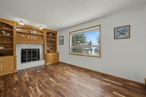 16 Straddock Crescent Sw, Calgary, AB - Indoor Photo Showing Living Room With Fireplace