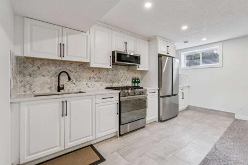 15 Brookmere Place Sw, Calgary, AB - Indoor Photo Showing Kitchen With Upgraded Kitchen