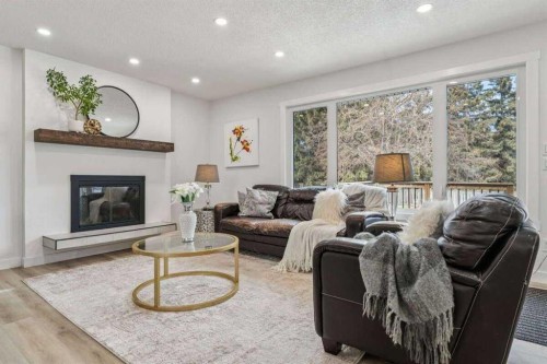 15 Brookmere Place Sw, Calgary, AB - Indoor Photo Showing Living Room With Fireplace