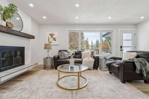 15 Brookmere Place Sw, Calgary, AB - Indoor Photo Showing Living Room With Fireplace