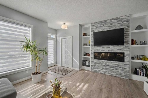 38 Sage Bluff Gate Nw, Calgary, AB - Indoor Photo Showing Living Room With Fireplace