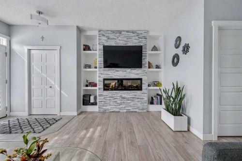 38 Sage Bluff Gate Nw, Calgary, AB - Indoor Photo Showing Living Room With Fireplace