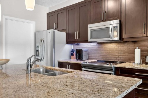 308-402 Marquis Lane Se, Calgary, AB - Indoor Photo Showing Kitchen With Double Sink With Upgraded Kitchen