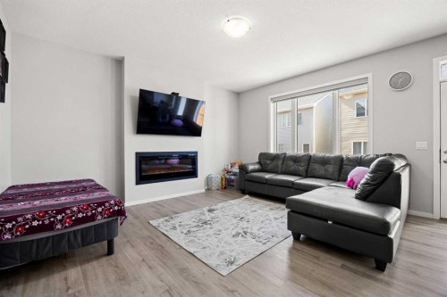 93 Cityline Square Ne, Calgary, AB - Indoor Photo Showing Living Room With Fireplace