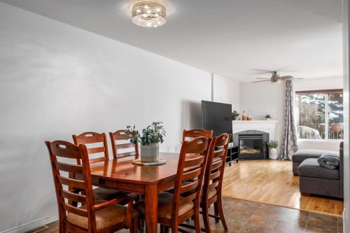 111-323 4 Avenue, Strathmore, AB - Indoor Photo Showing Dining Room With Fireplace