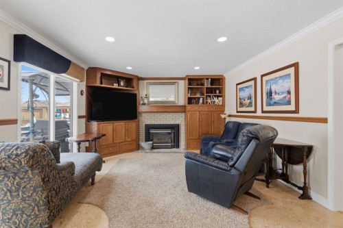 352 Oakside Circle Sw, Calgary, AB - Indoor Photo Showing Living Room With Fireplace
