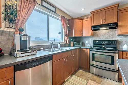 43 Sheep River Heights, Okotoks, AB - Indoor Photo Showing Kitchen With Double Sink