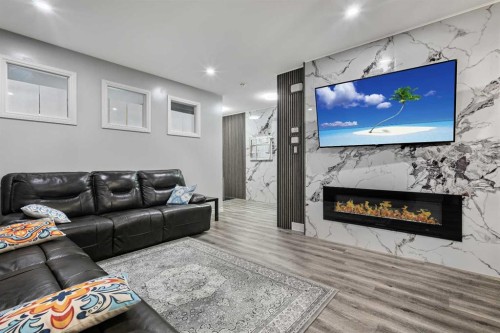 183 Cornerbrook Gate Ne, Calgary, AB - Indoor Photo Showing Living Room With Fireplace