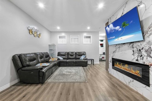 183 Cornerbrook Gate Ne, Calgary, AB - Indoor Photo Showing Living Room With Fireplace