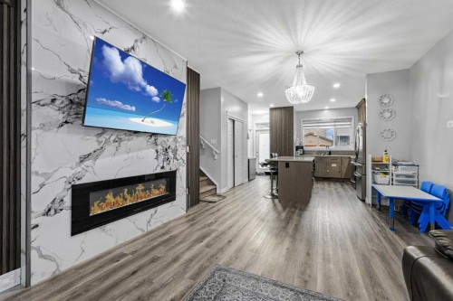 183 Cornerbrook Gate Ne, Calgary, AB - Indoor Photo Showing Living Room With Fireplace