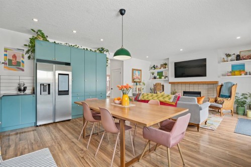 32 Chapalina Common Se, Calgary, AB - Indoor Photo Showing Dining Room With Fireplace