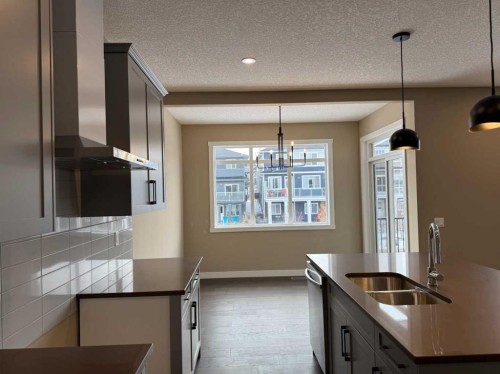 115 Sundown Crescent, Cochrane, AB - Indoor Photo Showing Kitchen With Double Sink