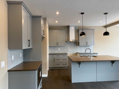 115 Sundown Crescent, Cochrane, AB - Indoor Photo Showing Kitchen With Upgraded Kitchen