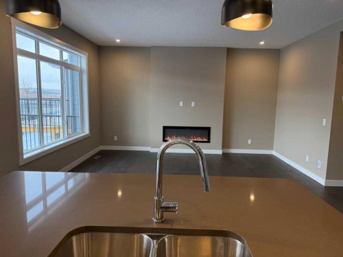 115 Sundown Crescent, Cochrane, AB - Indoor Photo Showing Kitchen With Double Sink
