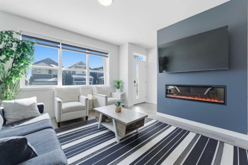 99 Aquila Way Nw, Calgary, AB - Indoor Photo Showing Living Room With Fireplace