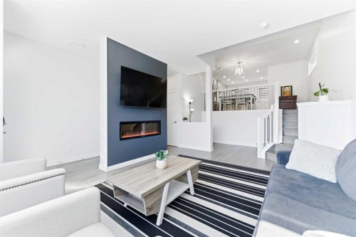 99 Aquila Way Nw, Calgary, AB - Indoor Photo Showing Living Room With Fireplace