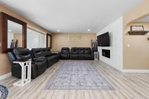 66 Royal Highland Road Nw, Calgary, AB - Indoor Photo Showing Living Room With Fireplace