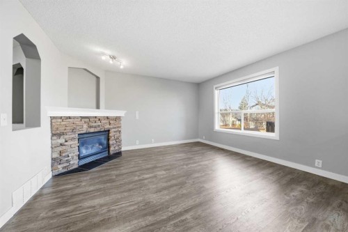 83 Cranfield Crescent Se, Calgary, AB - Indoor Photo Showing Living Room With Fireplace