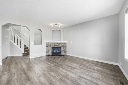 83 Cranfield Crescent Se, Calgary, AB - Indoor Photo Showing Living Room With Fireplace