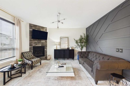 156 Rainbow Falls Heath, Chestermere, AB - Indoor Photo Showing Living Room With Fireplace