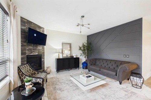 156 Rainbow Falls Heath, Chestermere, AB - Indoor Photo Showing Living Room With Fireplace