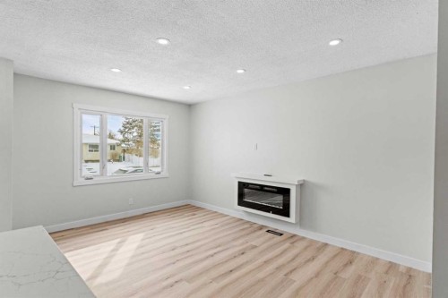 937 Marcombe Drive Ne, Calgary, AB - Indoor With Fireplace