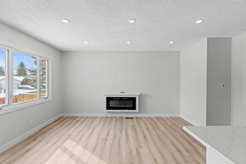937 Marcombe Drive Ne, Calgary, AB - Indoor With Fireplace