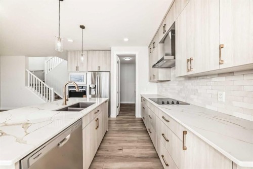 100 Corner Glen Manor Ne, Calgary, AB - Indoor Photo Showing Kitchen With Double Sink With Upgraded Kitchen