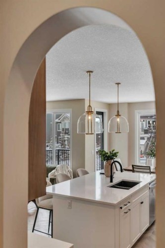 47 Sundown Crescent, Cochrane, AB - Indoor Photo Showing Kitchen With Double Sink