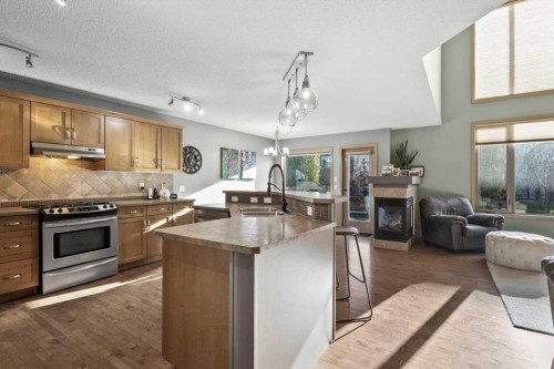 25 Tuscany Summit Terrace Nw, Calgary, AB - Indoor Photo Showing Kitchen With Fireplace With Double Sink