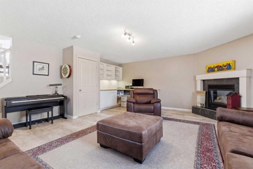 90 Cranberry Square, Calgary, AB - Indoor Photo Showing Living Room With Fireplace