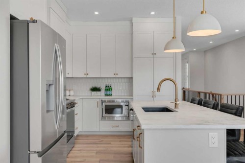 88 Sunrise Heath, Cochrane, AB - Indoor Photo Showing Kitchen With Upgraded Kitchen