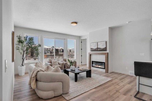 88 Sunrise Heath, Cochrane, AB - Indoor Photo Showing Living Room With Fireplace