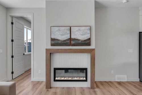 88 Sunrise Heath, Cochrane, AB - Indoor Photo Showing Living Room With Fireplace