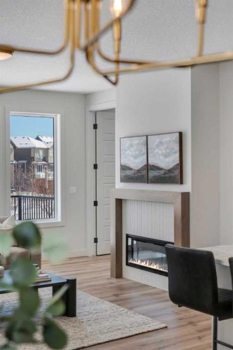 88 Sunrise Heath, Cochrane, AB - Indoor Photo Showing Other Room With Fireplace