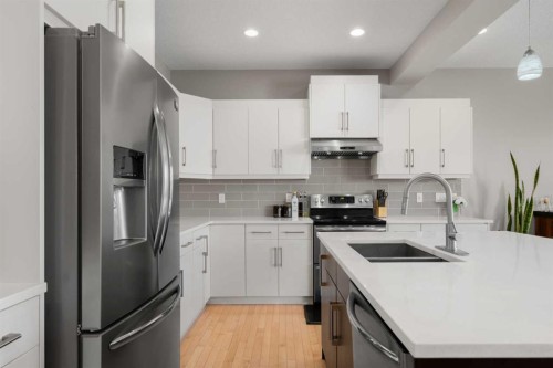 151 Heritage View, Cochrane, AB - Indoor Photo Showing Kitchen With Double Sink With Upgraded Kitchen