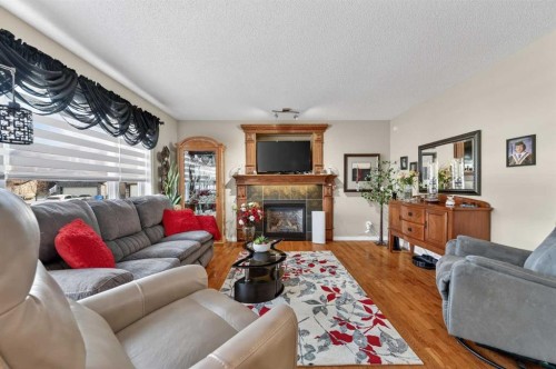 155 Morningside Circle Sw, Airdrie, AB - Indoor Photo Showing Living Room With Fireplace