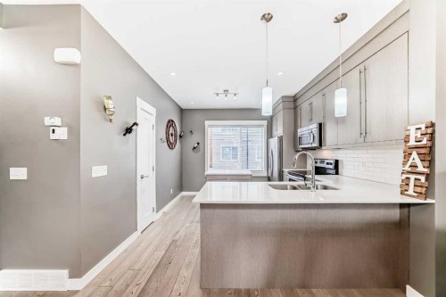53-111 Rainbow Falls, Chestermere, AB - Indoor Photo Showing Kitchen With Double Sink