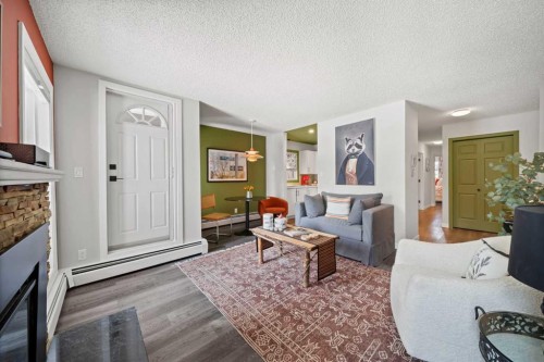 202-825 4 Street Ne, Calgary, AB - Indoor Photo Showing Living Room With Fireplace