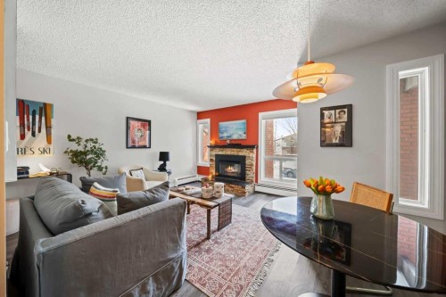 202-825 4 Street Ne, Calgary, AB - Indoor Photo Showing Living Room With Fireplace