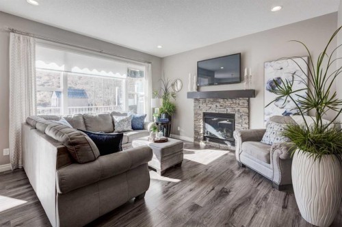 255 Riviera Way, Cochrane, AB - Indoor Photo Showing Living Room With Fireplace