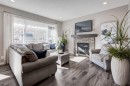 255 Riviera Way, Cochrane, AB  - Indoor Photo Showing Living Room With Fireplace 