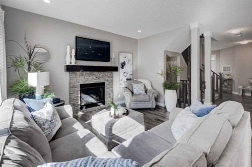 255 Riviera Way, Cochrane, AB - Indoor Photo Showing Living Room With Fireplace