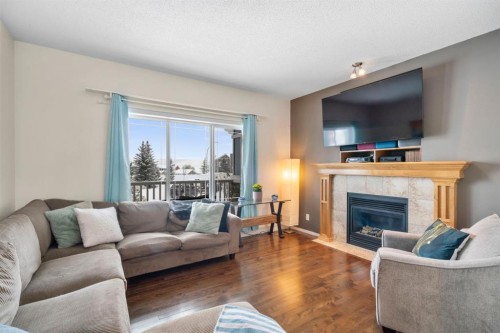 46 River Heights Boulevard, Cochrane, AB - Indoor Photo Showing Living Room With Fireplace
