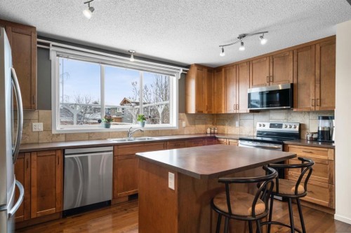 46 River Heights Boulevard, Cochrane, AB - Indoor Photo Showing Kitchen With Stainless Steel Kitchen With Double Sink