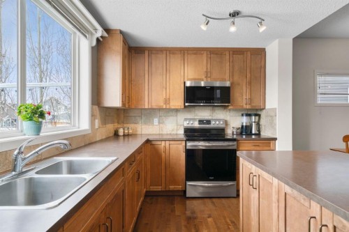 46 River Heights Boulevard, Cochrane, AB - Indoor Photo Showing Kitchen With Double Sink