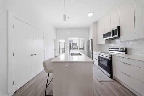 505-101 Panatella Square Nw, Calgary, AB - Indoor Photo Showing Kitchen With Double Sink