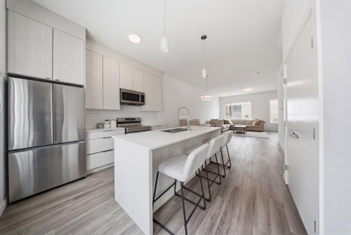 505-101 Panatella Square Nw, Calgary, AB - Indoor Photo Showing Kitchen With Stainless Steel Kitchen With Upgraded Kitchen