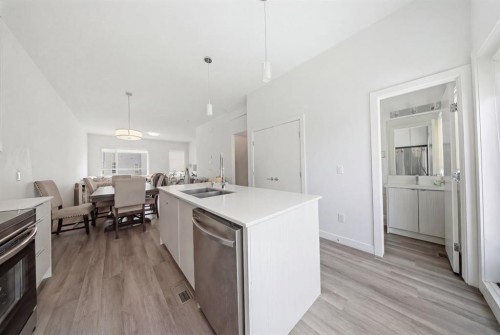 505-101 Panatella Square Nw, Calgary, AB - Indoor Photo Showing Kitchen With Double Sink