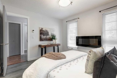 11 Woodfield Crescent Sw, Calgary, AB - Indoor Photo Showing Bedroom With Fireplace